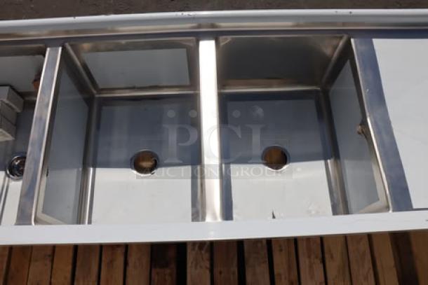 Brand new Regency 600S31824224 commercial sink, 106" stainless steel, 3 compartments, two 24" drainboards, slight cosmetic dents.