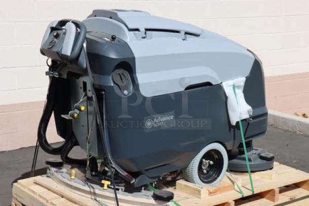 Advance SC901 ST 28D 28" cordless floor scrubber, new, with 30-gal tank, 710W motor, and accessories on a wooden pallet.