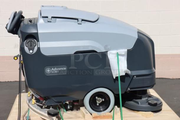 Advance SC901 ST 28D 28" cordless floor scrubber, brand new. Features 30-gallon tank, 250 RPM, 6 batteries, charger.