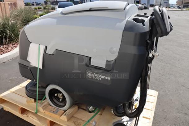 Brand new Advance SC901 ST 28D floor scrubber, 28" cleaning path, 30-gal tank, 36V, 250 RPM, with charger and pad holders.