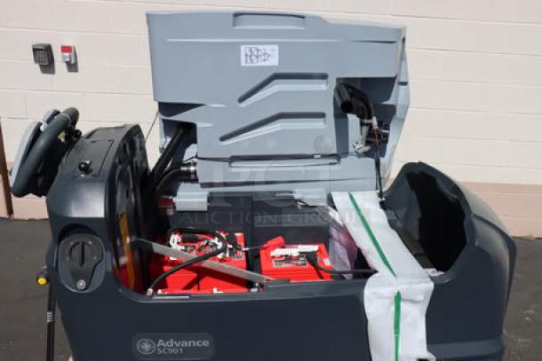 Brand new Advance SC901 ST 28D walk-behind floor scrubber, 28" cordless, with wet batteries, charger, and pad holders.
