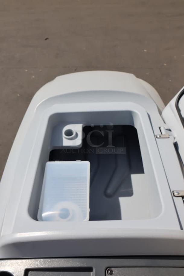 Advance SC901 ST 28D floor scrubber interior view, showing tank compartment. Brand new, 28" cordless, 36V, 30-gallon capacity.