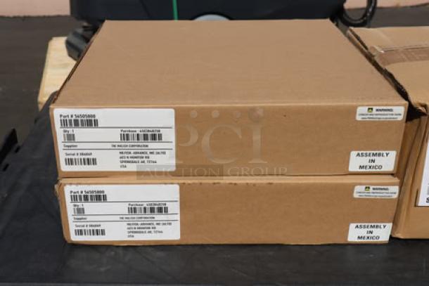 Cardboard boxes labeled "Part # 56409168," "Assembly in Mexico." Likely packaging for Advance SC901 scrubber accessories.
