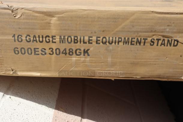 Box labeled "16 Gauge Mobile Equipment Stand 600ES3048GK," containing a Regency stainless steel work table, 30"x48", with backsplash.