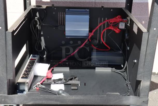 Newcastle Systems EcoCart mobile work station featuring power strip, cord holder, two rechargeable LiFePO4 batteries, and charging station, in new scratch-n-dent condition.