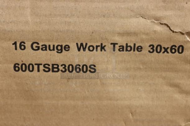 Regency 600TSB3060S stainless steel work table label on damaged box, indicating 16-gauge, 30"x60", with backsplash.