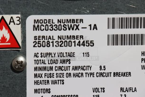Label on Scotsman MC0330SWX-1A ice machine showing model, serial number 25081320014455, voltage, and specs.
