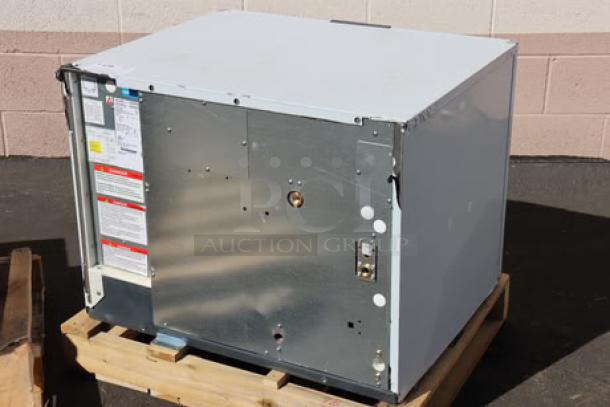 Brand new Scotsman MC0330SWX-1A Prodigy Elite® water-cooled ice machine on wooden pallet. Capacity: 372 lb., 115V. Model and serial numbers visible.