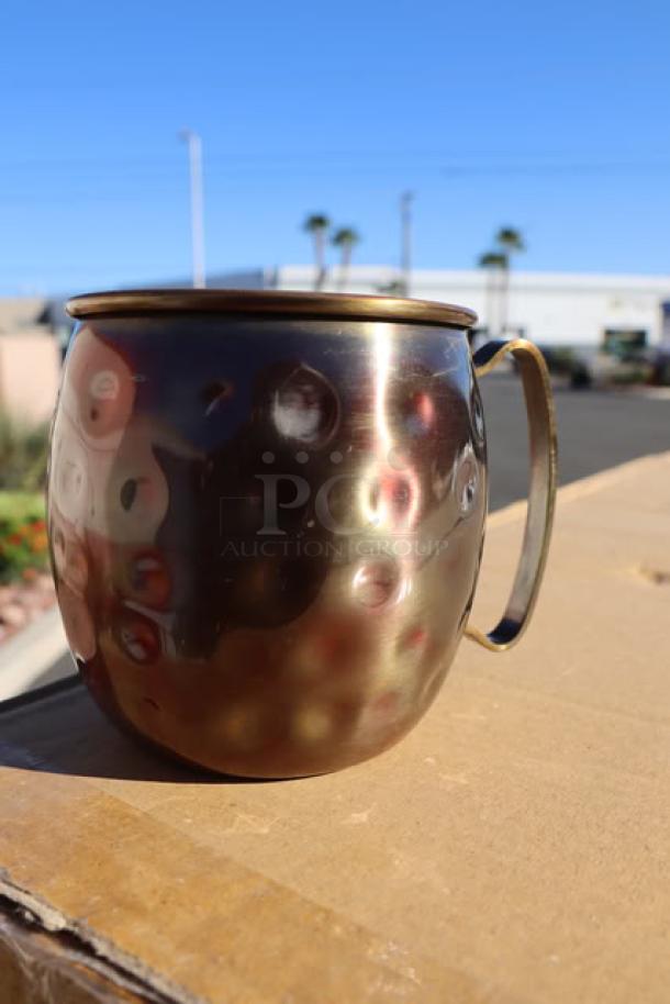 Acopa Alchemy 16 oz. Hammered Dark Antique Copper Moscow Mule Mug, model 553AQCMH16, shown unboxed on cardboard.