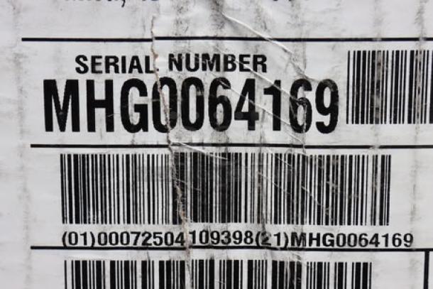 Brand new Bunn 35600.0020 BrewWISE MHG Coffee Grinder in original damaged packaging, S/N: MHG0064169, tags visible.