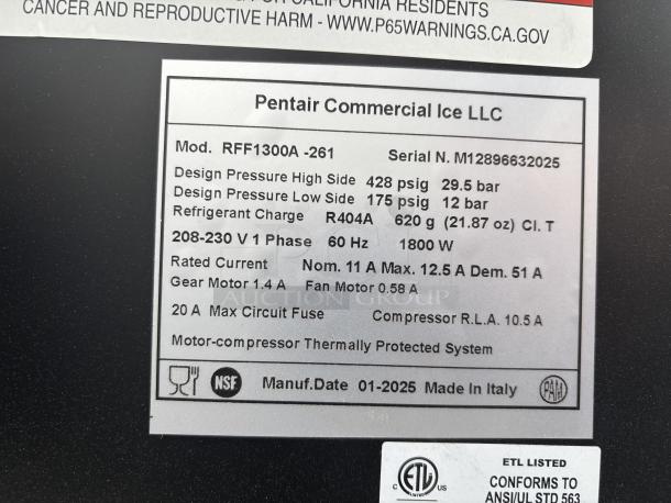 Brand new scratch-and-dent Manitowoc RFF1300A flake ice machine, 30" air-cooled, 1264 lb capacity, tags show technical specs.