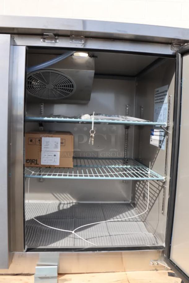 Avantco UDD-3-CT-S-6 kegerator interior with shelves, wires, box, and keys. Notable dent on bottom left side.