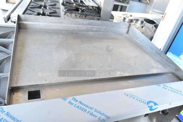 Brand new Vulcan 72SS-6B36GTN commercial 6-burner range; shows 36" griddle, 310,000 BTU, scratch and dent condition.