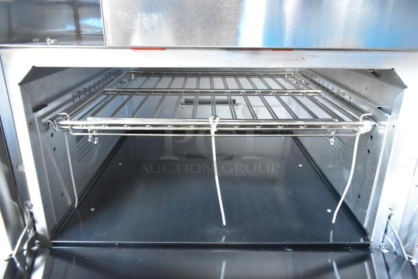 Interior of a Vulcan 72SS-6B36GTN commercial range showing clean oven racks and stainless steel construction.
