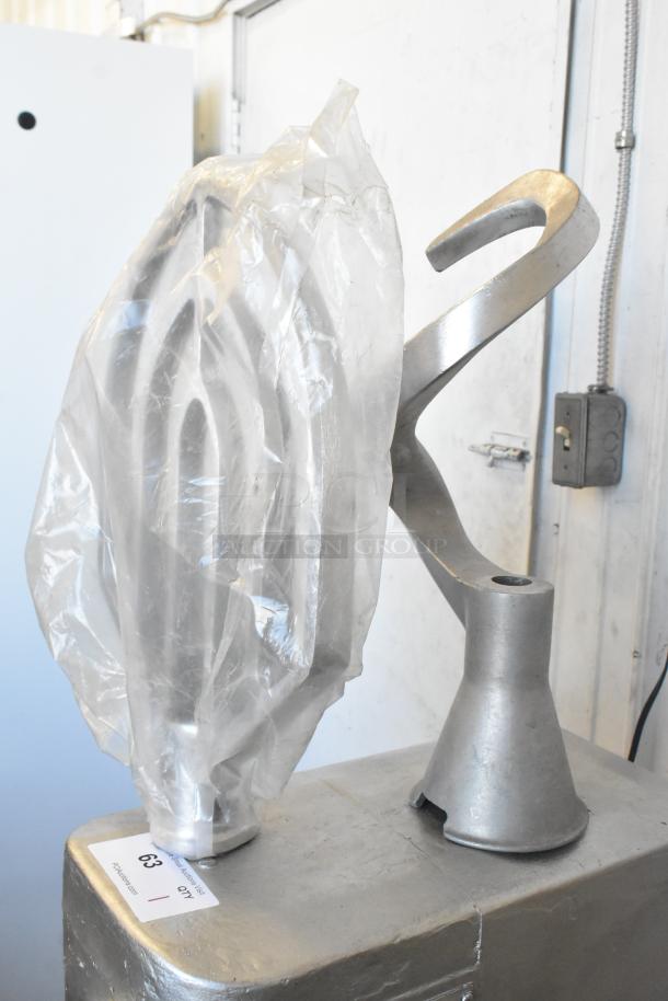 Globe SP40 planetary mixer attachments, including whisk, paddle, and dough hook. Visible plastic wrap and auction tag.