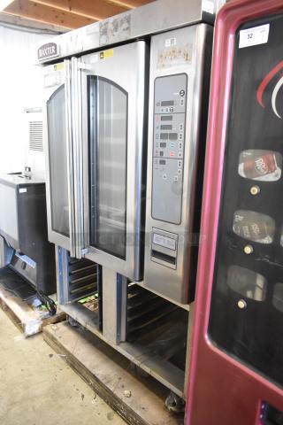 Baxter OV310G stainless steel commercial gas mini rotating rack oven. Right door non-functional. Includes double pan rack and casters.