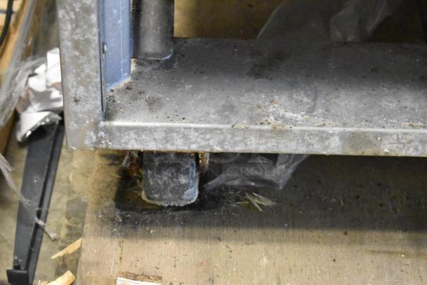 Baxter OV310G stainless steel rotating rack oven bottom with worn commercial caster. Right side door not functional.