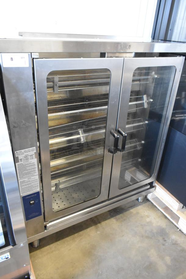 Brand new Pegasus CR-5E electric rotisserie oven with 5 spits, 208V, 3 Phase, scratch and dent condition. Tags visible.