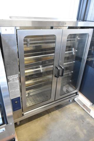 Brand new Pegasus CR-5E electric rotisserie oven with 5 spits, 208V, 3 Phase, scratch and dent condition. Tags visible.
