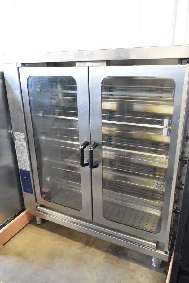 Brand new Pegasus CR-5E electric rotisserie oven, 5 spits, 208V, 3 phase. Minor scratches, labeling indicates "HOT."