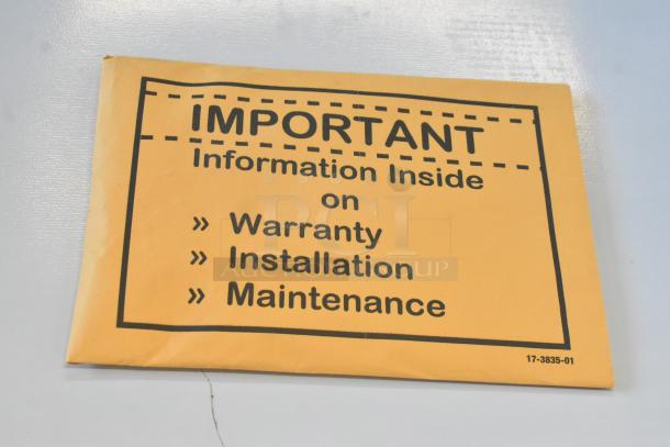 A Scotsman MC0330MAX-1A ice machine with envelope showing warranty, installation, and maintenance info included.