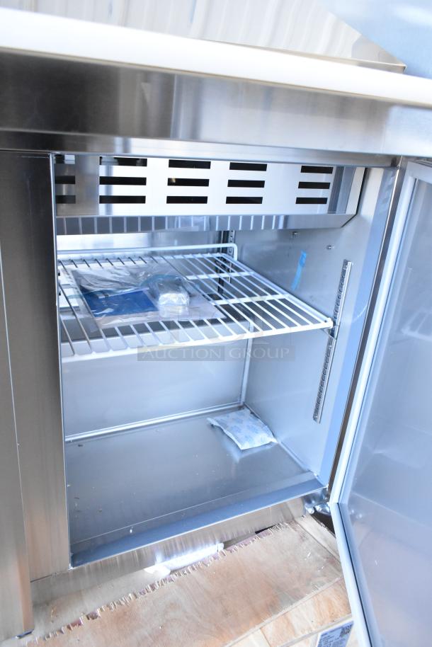 Brand new Avantco 178SSPT71MHC 70" stainless steel 3-door refrigerated sandwich prep table, interior view.