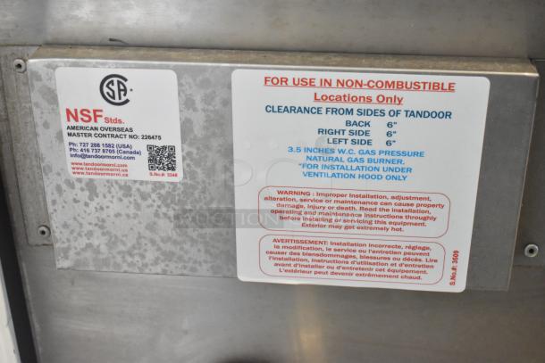 BRAND NEW SCRATCH AND DENT Tandoor Morni CS-02, stainless steel, 24"x24"x37" catering tandoor oven, 100,000 BTU. Model 17ACS02N. Important safety and installation labels visible.