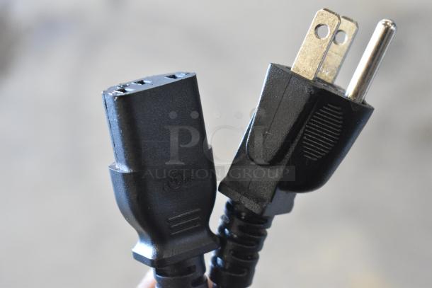 Close-up of the power plug for a VacPak-It 186VMC32 chamber vacuum packaging machine, showing a standard 110-120V connection.