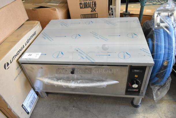 Brand new ServIt 423WDSFS1 freestanding single drawer warmer, 120V, 1 phase, slight scratch and dent, protective film visible.