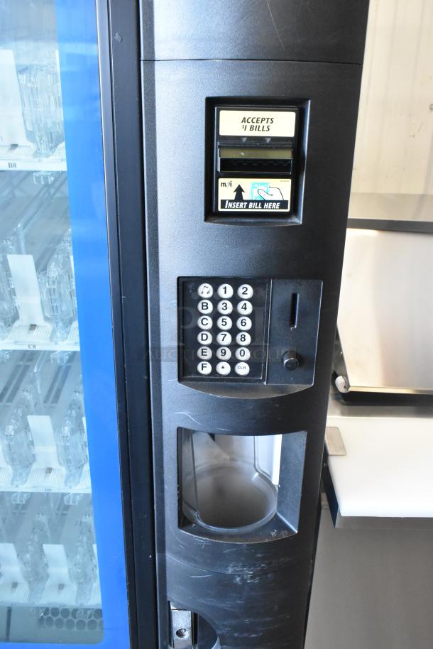 Commercial bottled drink vending machine with bill acceptor, keypad, and display. Good condition with visible slots.