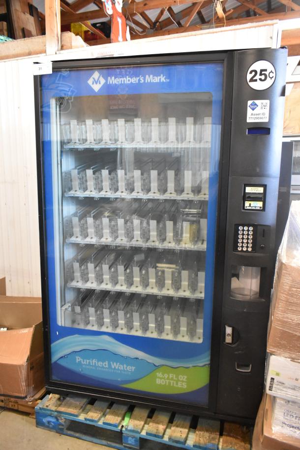 Commercial bottled drink vending machine with bill acceptor, branded Member's Mark. Features multiple rows for 16.9 fl oz bottles, priced at 25 cents.