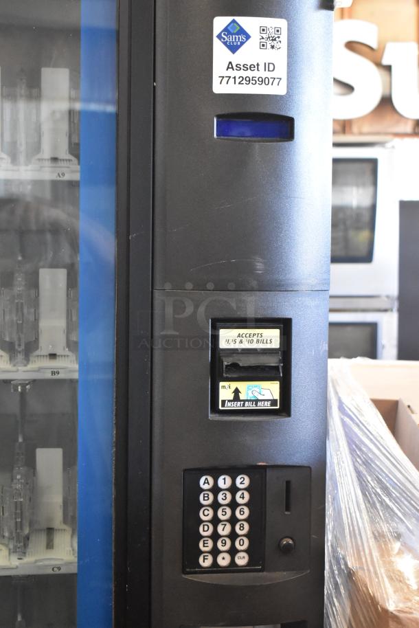Commercial bottled drink vending machine with bill acceptor. Features keypad, bill slot for $1, $5, $10 bills. Asset ID: 7712959077.