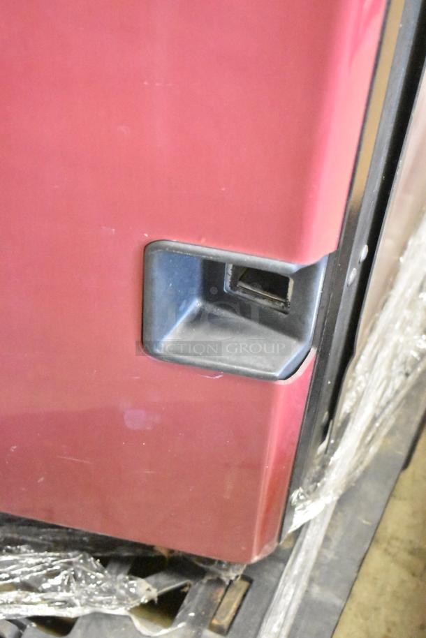 Red commercial canned drink vending machine with bill acceptor, 125 volts, 1 phase, used condition, visible handle and lower section.