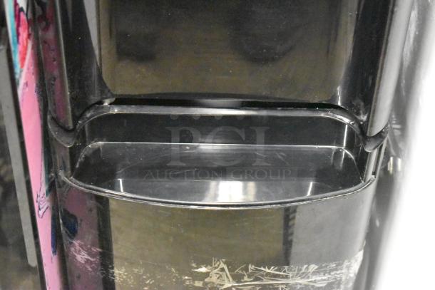 Primo 601088 black bottom load water dispenser, 115V, 1 phase. Visible scratches and wear on surface.