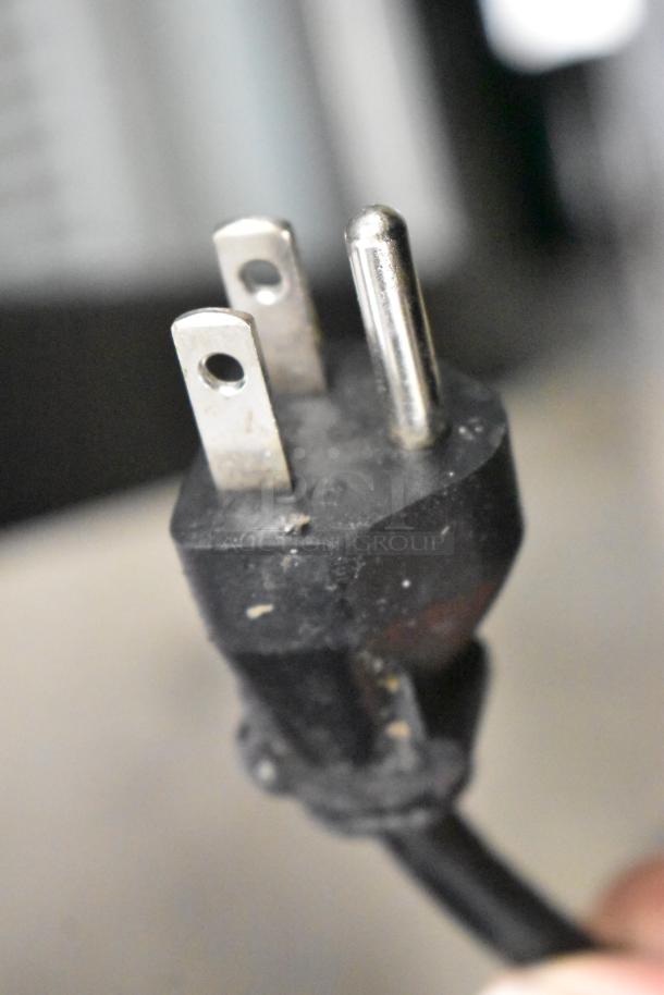 Close-up of a power plug from a Primo 601088 Black Bottom Load Water Dispenser, 115V, 1 Phase.