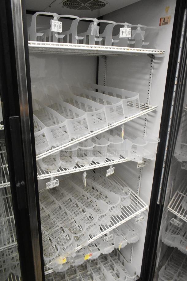 True GDM-52TM-RL-LD 2-door merchandiser cooler, 115V, empty interior with adjustable shelves, price labels attached.