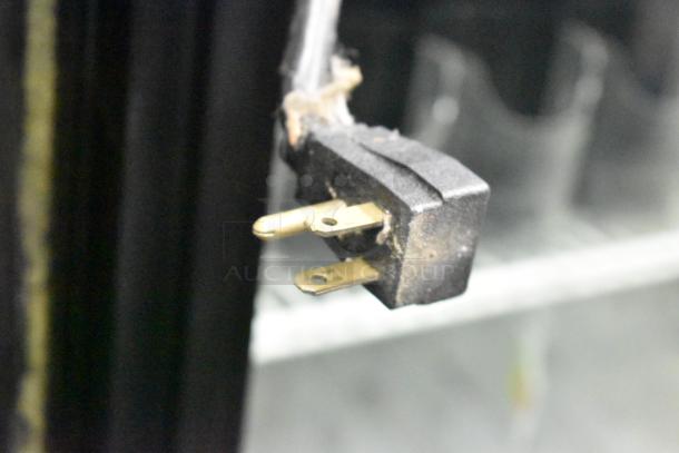 Power plug of the True GDM-52TM-RL-LD commercial reach-in cooler, 115 volts, 1 phase; some wear visible.