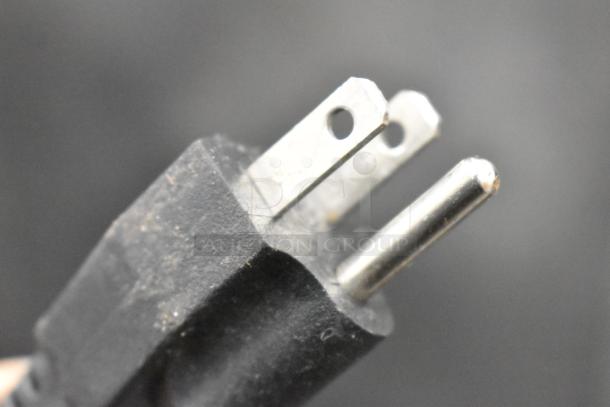 Close-up of a three-prong plug, part of the Vevor X-300 Commercial Slushie Machine, indicating 115 volts, 1 phase power compatibility.