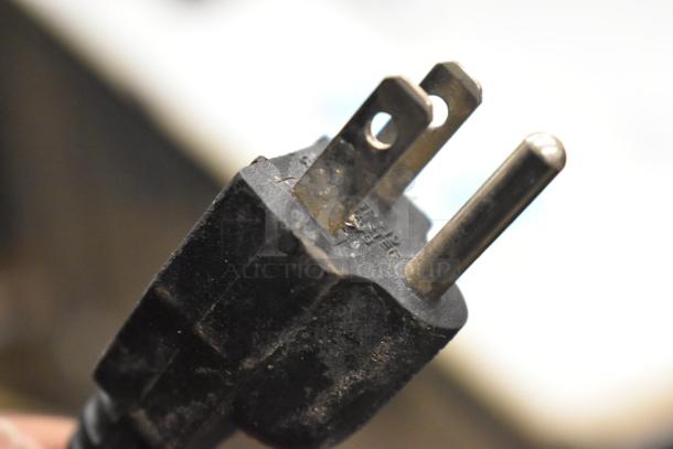 Close-up of a power plug for the Carter Hoffmann MZ223G warming unit, showing wear and standard 120-volt, 1-phase design.