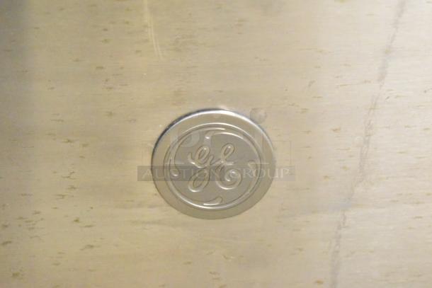 General Electric undercounter dishwasher with GE logo on stainless steel. 115 volts, 1 phase. Clean surface, minimal wear.