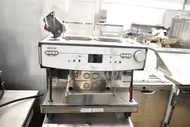 Schaerer Barista automatic 2 group espresso machine with 5 portafilters, steam wands, and clear labeling.