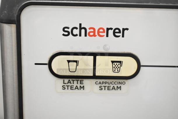 Schaerer Barista espresso machine control panel with latte and cappuccino steam buttons, model branding visible.