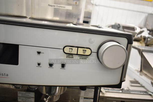 Schaerer Barista automatic espresso machine with 2 groups, 5 portafilters, and steam wands, controls for latte and cappuccino steam.