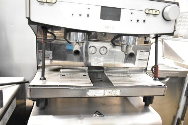 Schaerer Barista automatic 2 group espresso machine with 5 portafilters, steam wands, visible gauges, and operational labels.