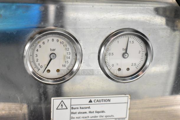 Schaerer Barista espresso machine with dual pressure gauges, stainless steel body, caution label; automatic, used condition.