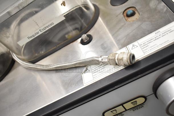 Schaerer Barista espresso machine with two groups, five portafilters, steam wands. Includes "Regular Espresso" label.