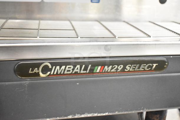 La Cimbali M29 Select 2 Group Espresso Machine, stainless steel, includes 2 portafilters, 2 steam wands, visible brand labeling.