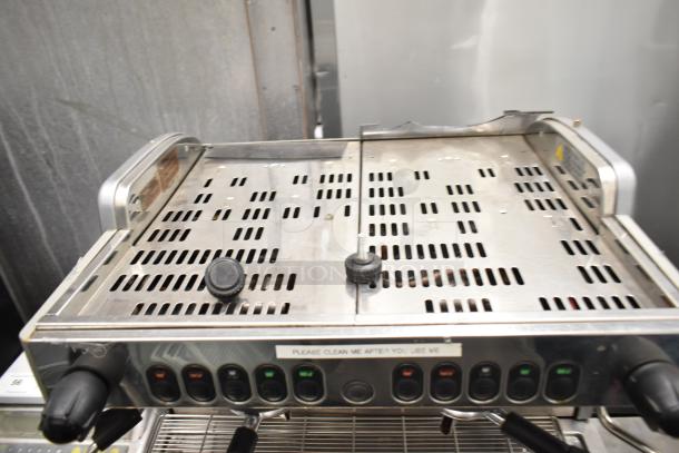 La Cimbali M29 Select espresso machine with 2 groups, 2 portafilters, and 2 steam wands. Sturdy, sleek design.