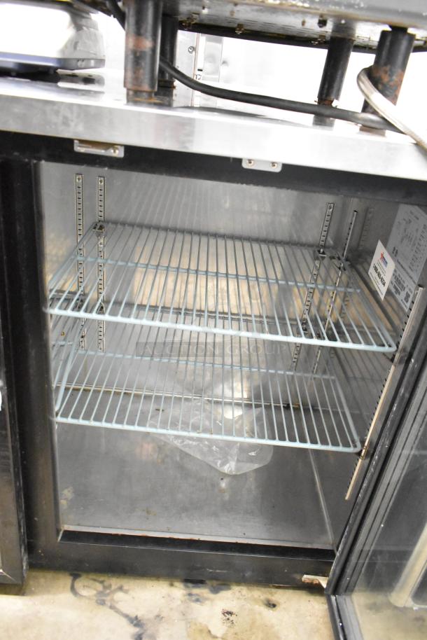 Omcan UBB-24-60G commercial two-door back bar cooler, glass doors, two wire shelves, 115 volts, visible interior.