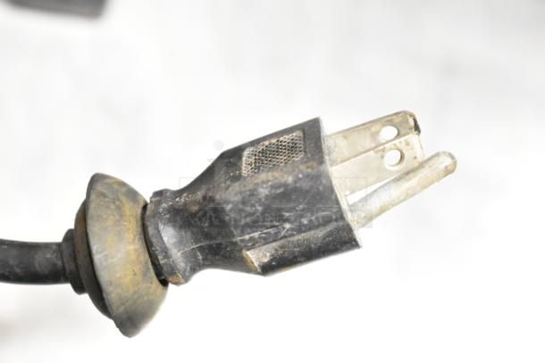 Close-up of a power plug for an Omcan UBB-24-60G commercial cooler, showing wear and possible dirt accumulation.